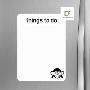 May include: White magnetic notepad with the text "things to do" at the top. A black and white illustration of a monkey covering its eyes is at the bottom. The notepad is on a silver refrigerator.