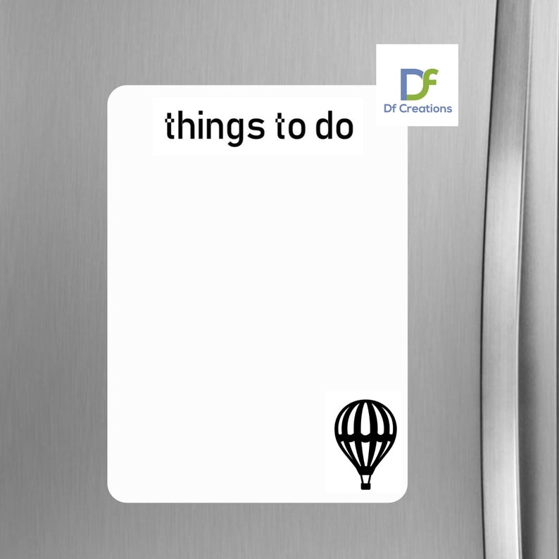 May include: White magnetic notepad with the text "things to do" at the top. A black hot air balloon icon is at the bottom. The notepad is on a silver refrigerator.