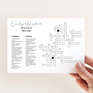 May include: A black and white printable crossword puzzle with the title "Emily & Robert Sip & Solve". The crossword puzzle is designed for a wedding shower or bridal shower game.