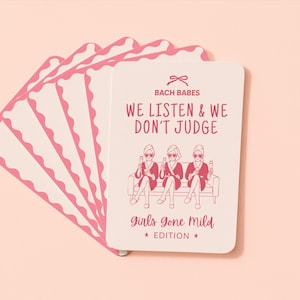 May include: A deck of rectangular playing cards with rounded, scalloped edges. The top card features a pink bow icon, the text BACH BABES, WE LISTEN & WE DON'T JUDGE, and an illustration of three people in robes holding glasses, with Girls Gone Mild EDITION at the bottom.