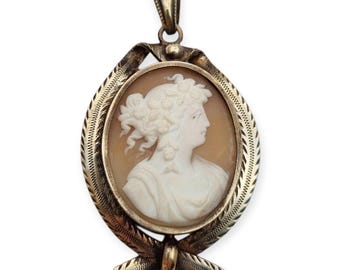 Antique carved shell cameo locket, circa 20th century, with a metal mount. Retro gifts for collectors, vintage accessories and jewelry.