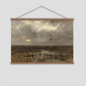 A large hanging tapestry featuring a dark and moody landscape painting of a marsh, the sun trying to come out from behind the clouds and birds flying overhead.  The tapestry it strimmed at the top and bottom with oak battons and an adjustable vegan friendly cord so you cna hang the tapestry at the right height