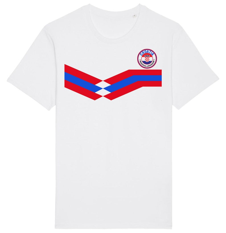 May include: White t-shirt with a red, white, and blue chevron design and a circular logo with the text "Croatia" and a checkered pattern.