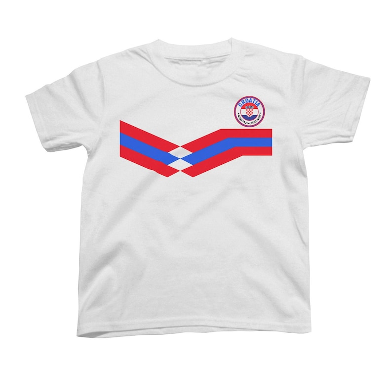May include: White t-shirt with a red, white, and blue chevron design and a circular logo with the text "CROATIA" and a coat of arms.