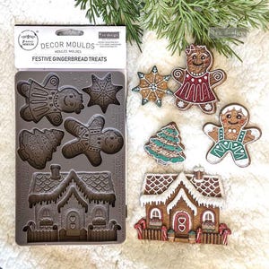 May include: A silicone mould for festive gingerbread treats, featuring gingerbread men, stars, a Christmas tree, and a house. Several decorated gingerbread biscuits are displayed, with icing and colourful details. The package reads "FESTIVE GINGERBREAD TREATS."