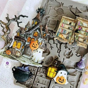 May include: Halloween-themed silicone moulds featuring a haunted house, pumpkins, ghosts, cauldrons, and bookshelves. The moulds are in various shapes and sizes, with intricate details and a spooky aesthetic. The colour palette includes orange, black, and grey.