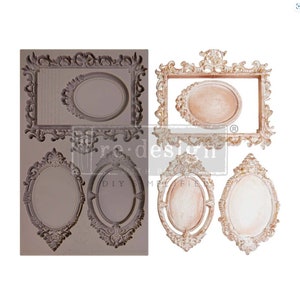 May include: A grey silicone mould featuring four ornate, vintage-style picture frame designs. The frames are rectangular and oval, with detailed scrollwork. The image also shows three finished frames in cream and gold.
