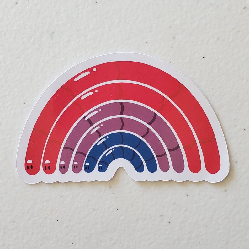 May include: A rainbow sticker with red, purple and blue stripes. The rainbow is made up of worm-like shapes with eyes.