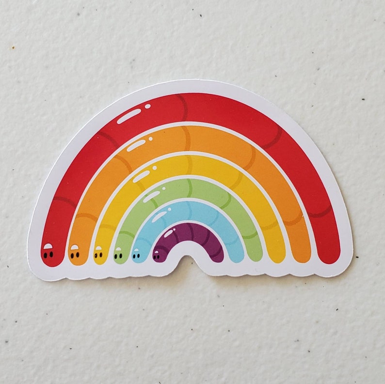 May include: A rainbow sticker featuring a worm design. The rainbow is made up of red, orange, yellow, green, blue, purple, and indigo worms. Each worm has two small black eyes.
