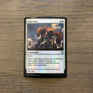 May include: A white bordered Magic: The Gathering card with a blue background and a silver foil finish. The card is titled "Seal Away" and has a white mana symbol and a blue mana symbol. The card art depicts a large, metallic, orange creature with a blue sky and clouds in the background. The card text reads: "Flash. When Seal Away enters the battlefield, exile target tapped creature an opponent controls until Seal Away leaves the battlefield. An ancient nemesis rendered harmless long ago."
