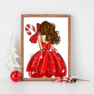 Op de afbeelding: Een ingelijste illustratie van een vrouw in een rode jurk die een zuurstok vasthoudt. De jurk is versierd met witte stippen. Het kunstwerk heeft een kerstthema en wordt op een wit oppervlak gepresenteerd.
