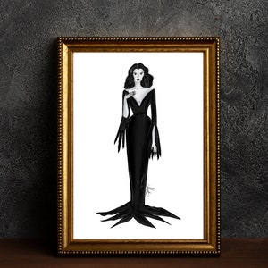 May include: A framed art print showing a monochrome illustration of a woman in a long, black dress with a low neckline and flowing sleeves. The artwork is set against a white background within a gold-coloured frame.