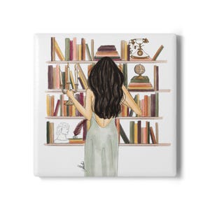 May include: A watercolor illustration of a person with long dark hair wearing a light green dress, standing before a bookshelf filled with colorful books, a vintage telephone, a globe, a candelabra, a small white bust, and a dark feather quill.