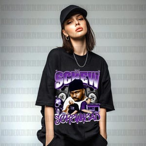 May include: Black t-shirt with a graphic design featuring DJ Screw. The design includes the text "DJ Screw" in purple and white, images of speakers, a skull, and the text "Screwhead" in purple.