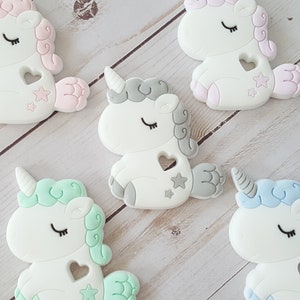 Magical unicorn baby toy. Soft gift. Gray, purple, blue, green, pink. Mystical nursery theme.