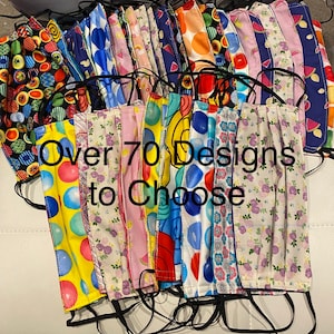 May include: A collection of over 70 colorful fabric face masks with various patterns, including polka dots, stripes, and floral designs.  The masks are pleated and have black elastic ear loops.  The text "Over 70 Designs to Choose" is visible in the image.