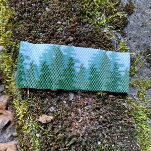 Cuff bracelet using 11/0 Delica beads and peyote stitch. Lovely scene of conifer forrest. Pattern purchased from BeadingWithBugs. image 1