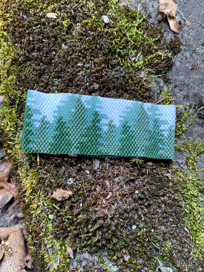 Cuff bracelet using 11/0 Delica beads and peyote stitch. Lovely scene of conifer forrest. Pattern purchased from BeadingWithBugs. image 1