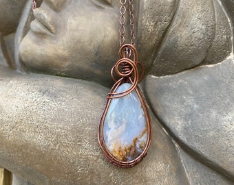 Plume agate pendant wire wrapped/weaved with copper wires. Free copper plated chain included.