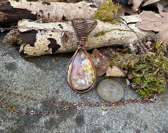 Ocean fossil jasper pendant wire wrapped and weaved with copper wires. Complimentary copper plated chain included.