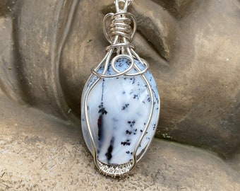 Faceted dendritic opal pendant wire wrapped with Argentium sterling silver wires. Free silver plated chain included.