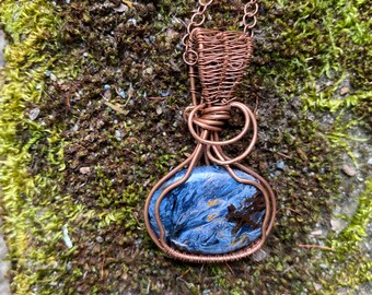 Stunning blue Pietersite pendant wire wrapped and weaved with copper wires and hung from copper plated chain.