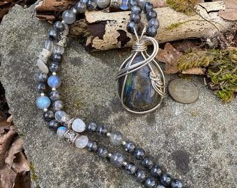 Labradorite pendant wire wrapped with Argentium silver wires and hung from a strand of Labradorite beads with silver accents.