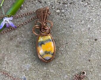 Bumble Bee Jasper pendant wire wrapped/weaved with copper wires and hung from copper plated chain.