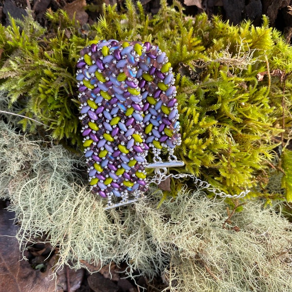 Cuff bracelet hand stitched with SuperDuo beads in purples and green. Comfortable bracelet that is adjustable.