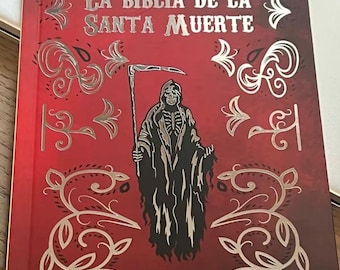 May include: A red book with a silver design featuring a skeletal figure in a hooded robe holding a scythe. The title of the book is "La Biblia de la Santa Muerte".