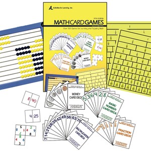 May include: A Math Card Games educational kit featuring a yellow instruction book, a blue abacus with yellow and black beads, yellow fraction charts, and various card decks including Money, Basic Number, Multiplication, and Fraction sets.