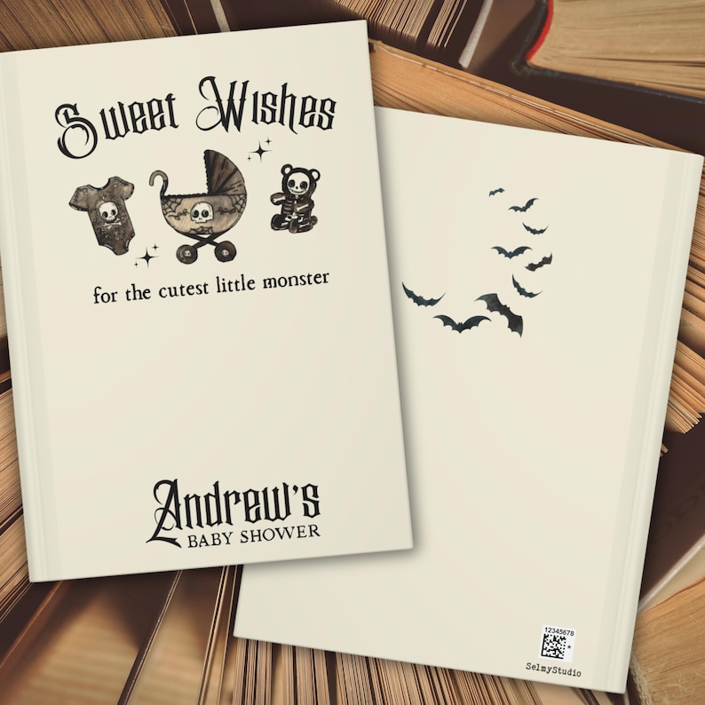 May include: Off-white baby shower invitation with the text "Sweet Wishes" and "for the cutest little monster." The front features a skull-themed onesie, stroller, and teddy bear. The back has a bat design. The invitation is for Andrew's baby shower.