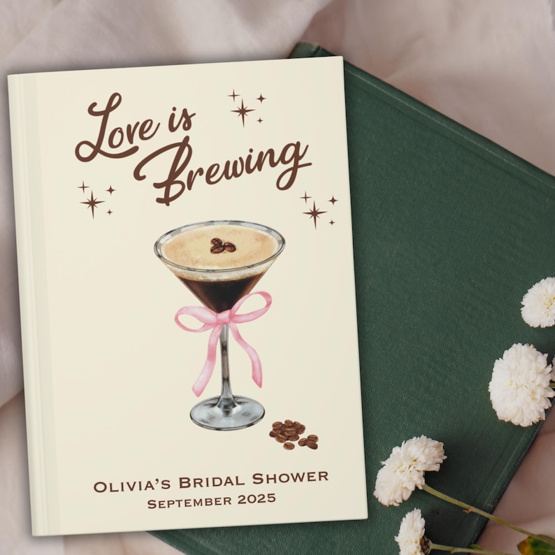 May include: A cream-colored bridal shower guest book with the text "Love is Brewing" and a martini illustration. The martini has a pink bow and coffee beans. The text "Olivia's Bridal Shower September 2025" is at the bottom.