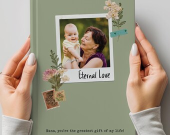 May include: A sage green photo album featuring a framed photo of a baby and an older woman with the text "Eternal Love." The album is decorated with floral accents and the phrase "Nana, you're the greatest gift of my life!"