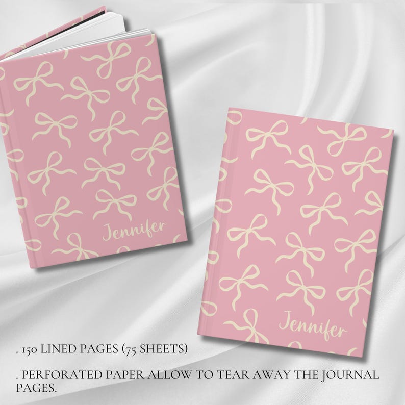 May include: A pink journal with a white bow pattern and the name "Jennifer" printed on the cover. The journal has 150 lined pages and perforated paper that allows you to tear away the pages.