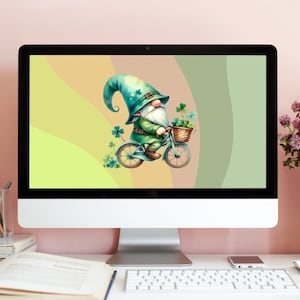 May include: A computer screen displaying a digital illustration of a green gnome riding a bicycle with a basket of shamrocks. The background is a gradient of yellow, green, and brown.