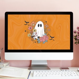 May include: A computer screen displaying a digital illustration of a ghost with flowers and bats on an orange background.