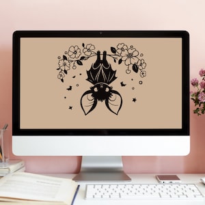 May include: A black silhouette of a bat hanging upside down from a branch with white flowers. The background is a light brown color.