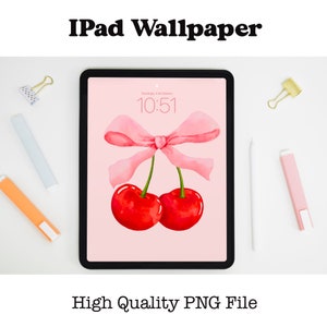 May include: A pink iPad screen with a digital clock displaying 10:51. The background is a light pink with two red cherries and a pink ribbon tied in a bow.