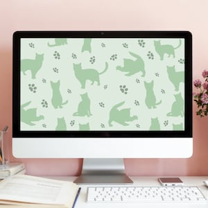 May include: A computer screen displaying a light green background with a repeating pattern of silhouettes of cats and paw prints.