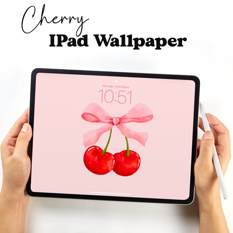 May include: A pink iPad with a pink bow and two red cherries on a pink background. The time is 10:51.