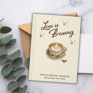May include: A cream-colored bridal shower invitation with the words "Love is Brewing" in brown script. The invitation features a coffee cup with latte art, a saucer, and coffee beans. The text "Sara's Bridal Shower September 28, 2025" is also included.