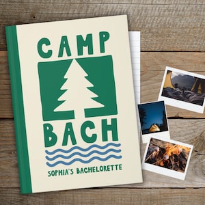 May include: A cream-colored notebook with the words "CAMP BACH" in green, featuring a green tree graphic and blue wavy lines. The notebook is labeled "SOPHIA'S BACHELORETTE" and includes three small photos of camping scenes.