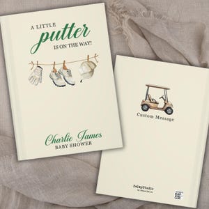 May include: A baby shower guest book with a golf theme. The cover features the text "A Little Putter Is On The Way!" with illustrations of golf shoes, a glove, and a hat. The back cover has a golf cart illustration.