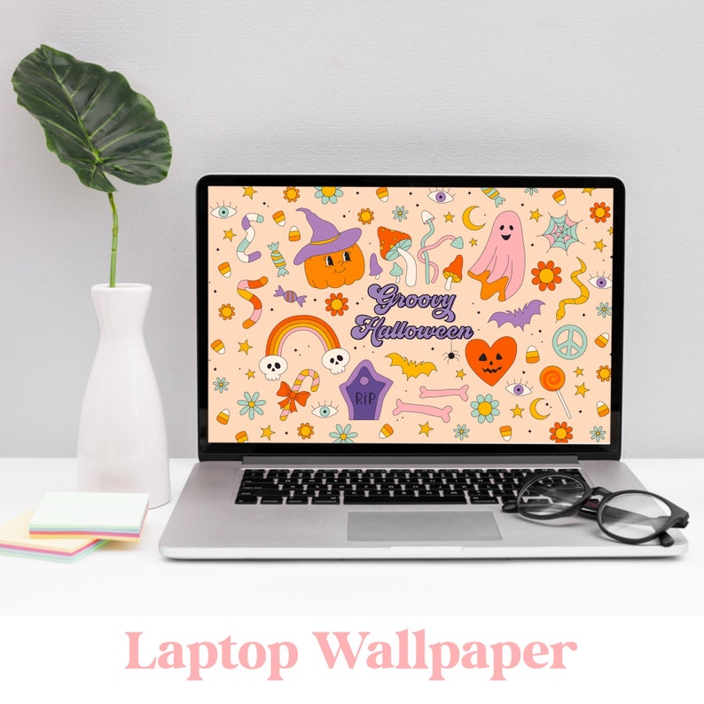 May include: A laptop computer with a groovy Halloween themed wallpaper. The wallpaper features a variety of colorful illustrations, including a pumpkin, a ghost, a rainbow, and a bat. The text "Groovy Halloween" is displayed in a retro font.