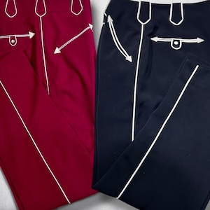 May include: Two pairs of pants with white piping. One pair is burgundy and the other is black.