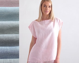 May include: A pink linen pyjama top and shorts set. The top has a boat neck and short sleeves. The shorts have a wide waistband and a relaxed fit.