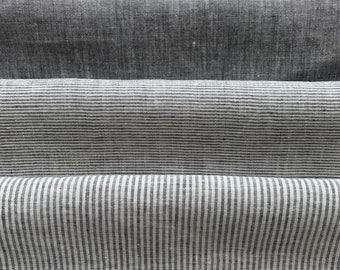 May include: Three pieces of fabric, one solid grey, one with thin white stripes, and one with thicker white stripes.