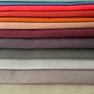 May include: A stack of 14 fabric swatches in various colors, including yellow, teal, blue, red, orange, brown, burgundy, gray, beige, and white.
