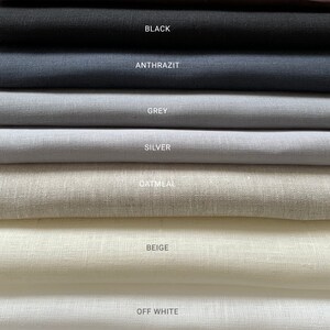 May include: A stack of fabric swatches in various shades of white, beige, gray, black, and brown. The swatches are labeled with their color names: Optical White, Off White, Beige, Oatmeal, Silver, Grey, Anthrazit, Black, and Brown.